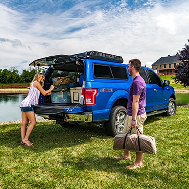 Couple unloading things from the blue truck