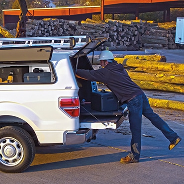 Couple unloading things from the blue truck